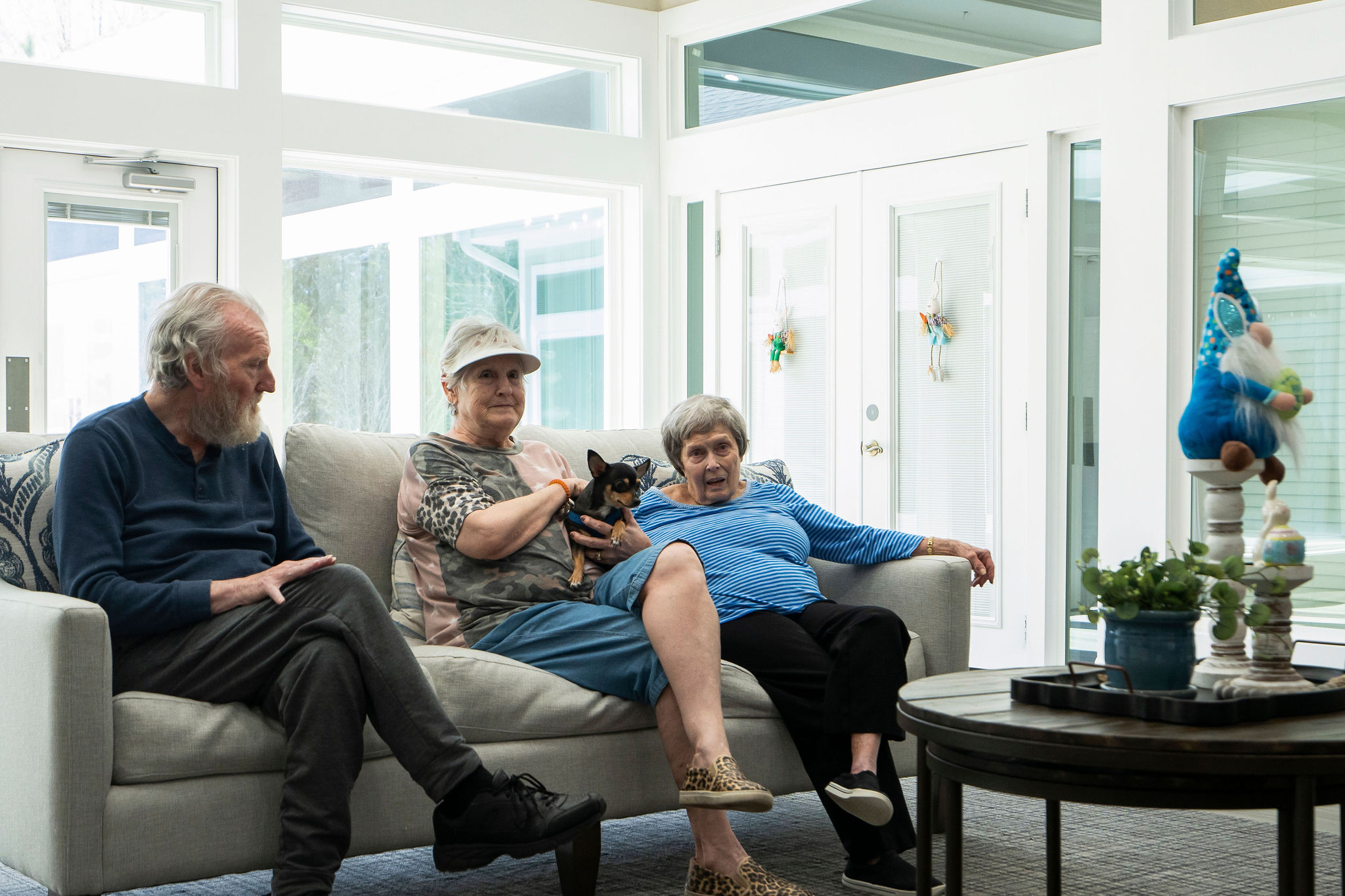 seniors in assisted living spending time together in a common area with their pets