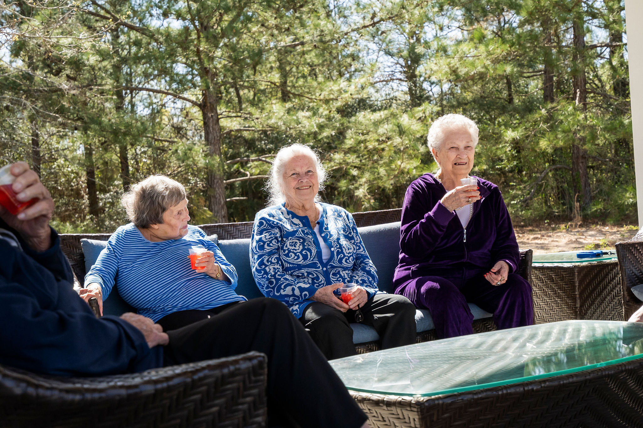 Three assisted living residents enjoying lemonade