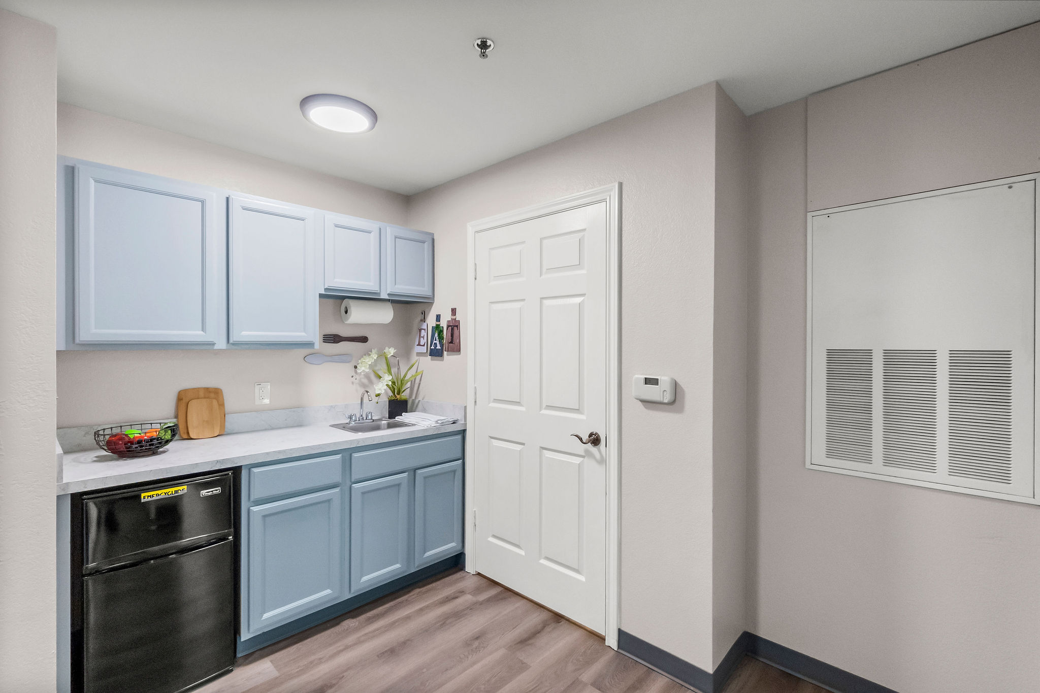 The kitchen and pantry of an apartment at Sundale Senior Living in Huntsville, TX